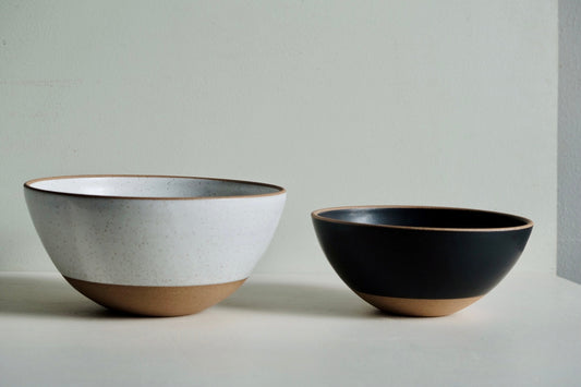 A medium-to-large serving bowl with a 3/4 glaze dip in black.