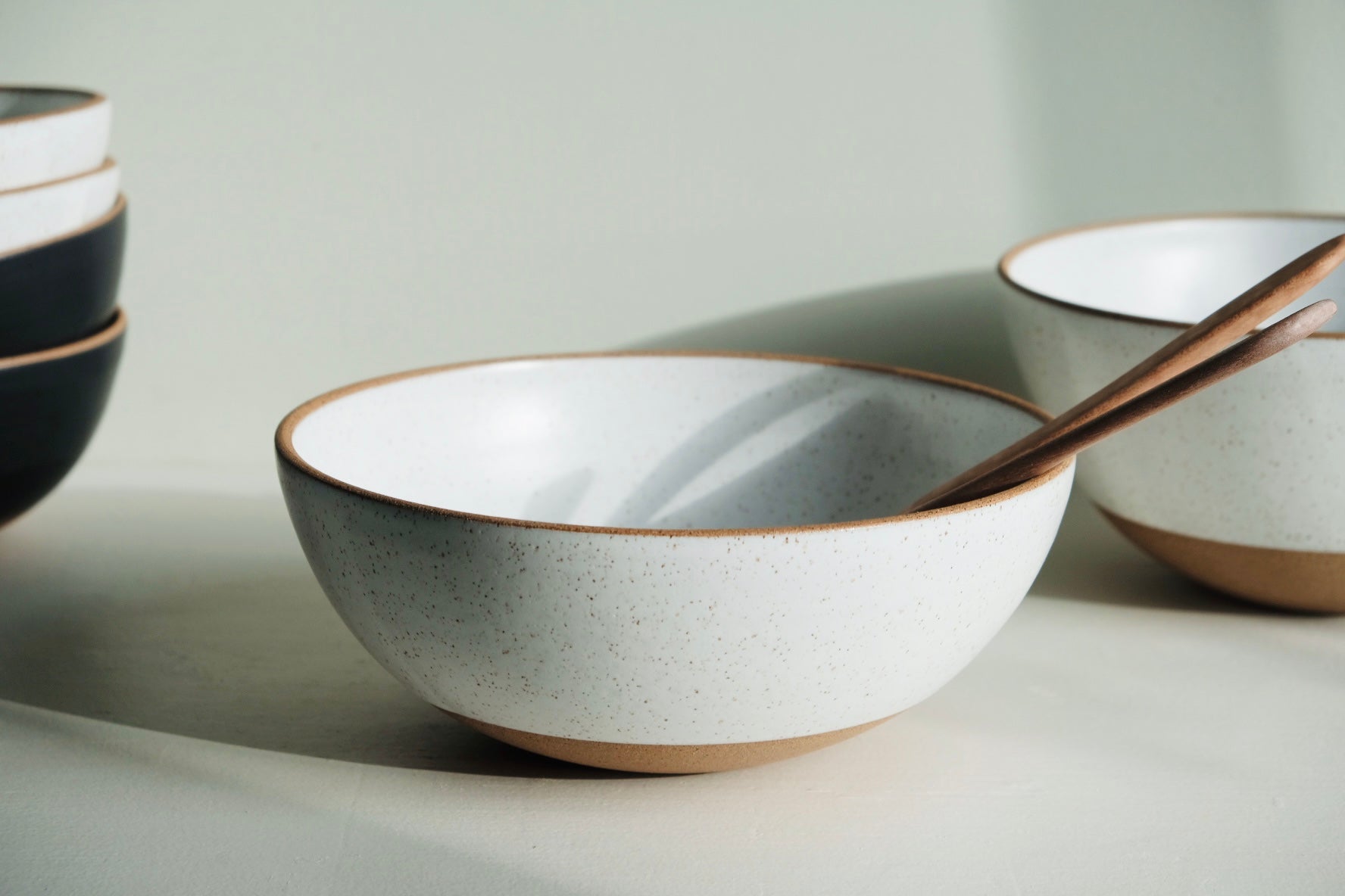 A medium-to-large serving bowl with a 3/4 glaze dip in white.