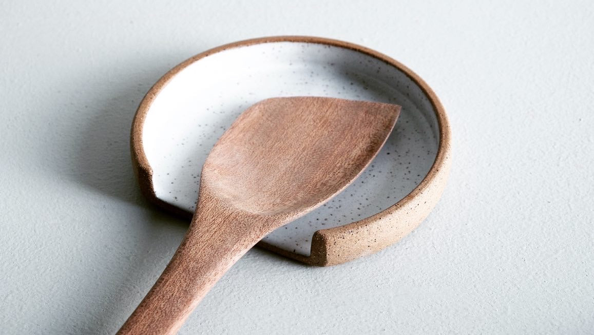 A circular spoonrest with a linear slice cut off the bottom for placing your spoon.
