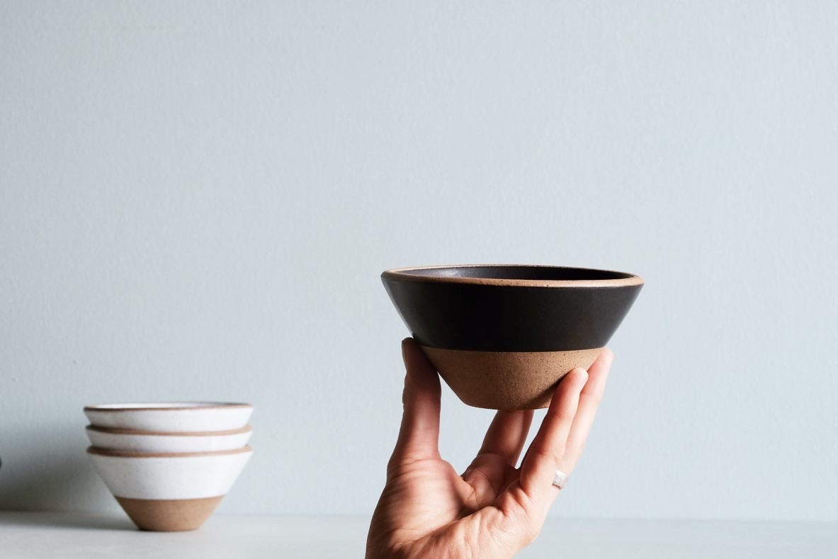 A bowl 3/4 dipped in black satin glaze.